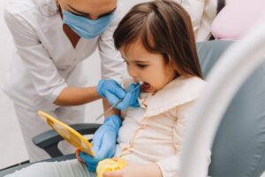 young girl sitting on a dental chair