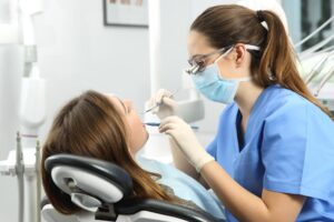 dentist examines a patient's teeth